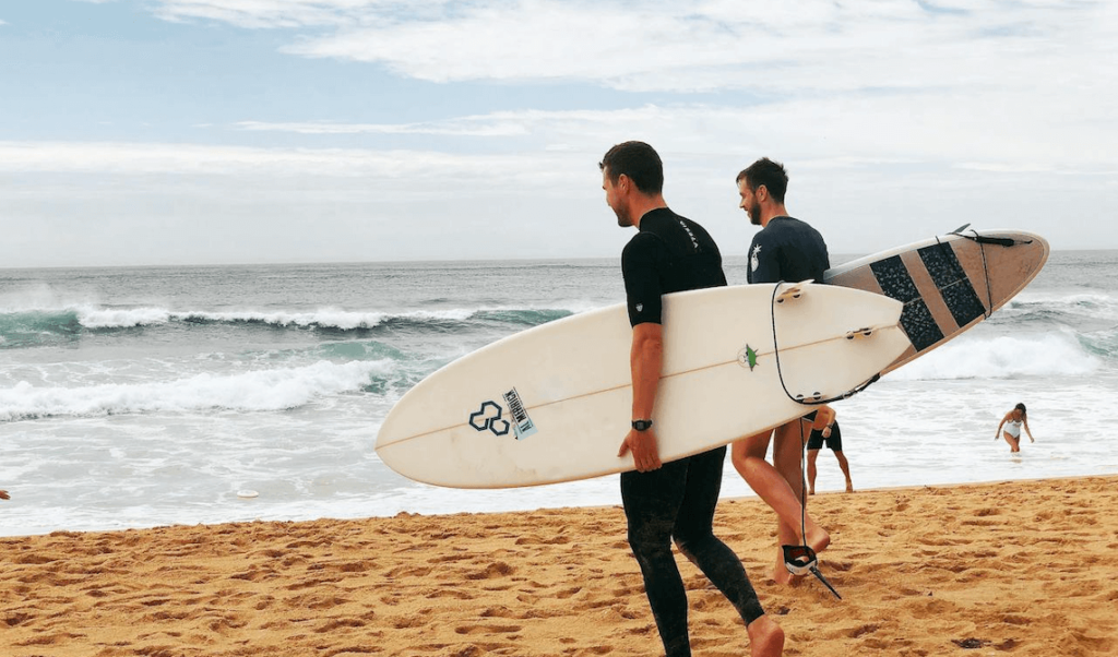 mens health, men talking and preparing to go surfing